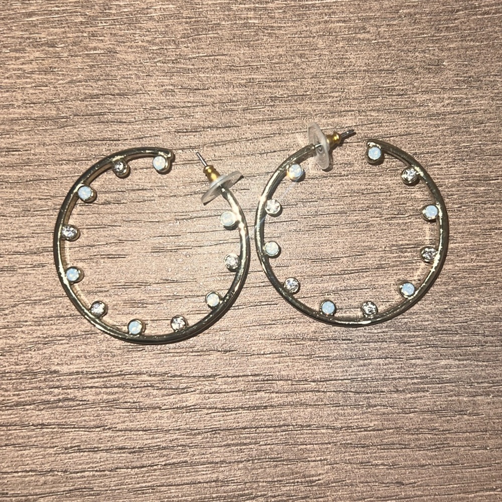 Gold hoop earrings with crystals on inside